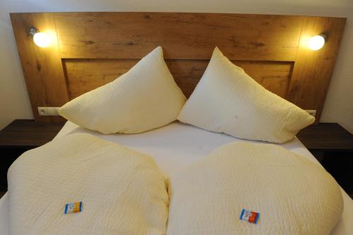 a bed with two white pillows on top of it at Apart Alpinlive in Ladis