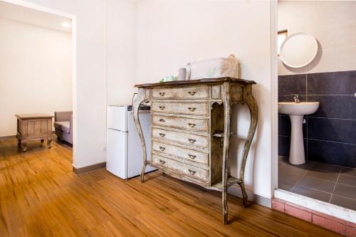 an old dresser in a room with a sink at CandyFloss 棉花糖民宿 遊高雄 in Kaohsiung