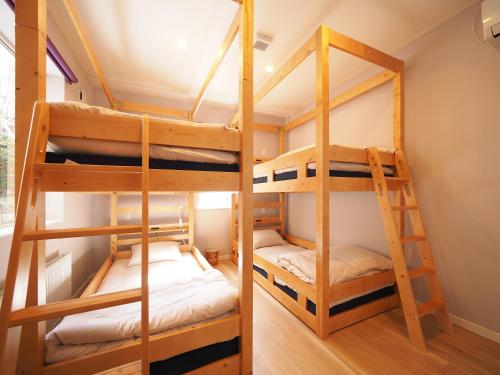 a bunk bed room with two bunk beds at Family Tree Guest House in Sapporo