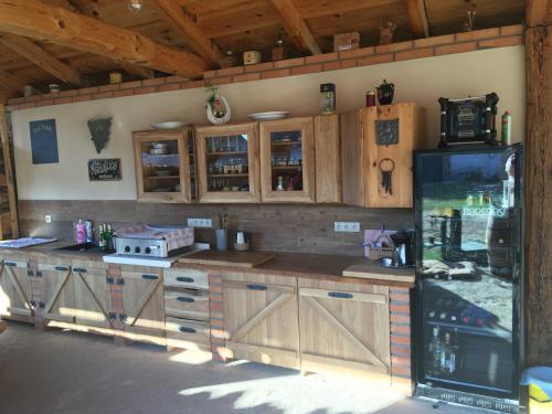 a large kitchen with wooden cabinets and a refrigerator at Apartmány Patriot in Třeboň