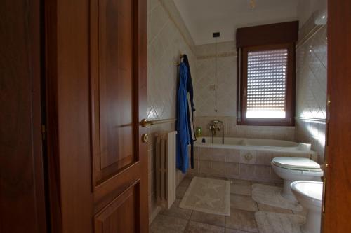 a bathroom with a tub and a toilet and a sink at ACQUARIO DEI FRALLE in Oristano