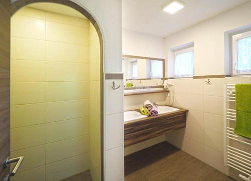 W łazience znajduje się umywalka i lustro. w obiekcie Ferienwohnung Alpklang w mieście Untertauern