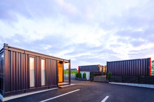 a rendering of a house in a parking lot at HOTEL R9 The Yard Utsunomiya chuo in Utsunomiya