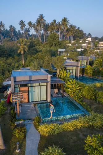 an aerial view of a house with a swimming pool at SEAnery Beach Resort in Bang Saphan