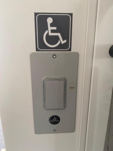a sign for a handicapped accessible sign on a wall at Just-Sleep in Brande