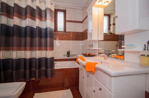 a bathroom with a sink and a tub and a shower at Harision Residence in Sparta