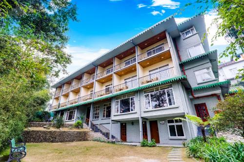 an apartment building with stairs leading up to it at Summit Barsana Resort & Spa in Kalimpong