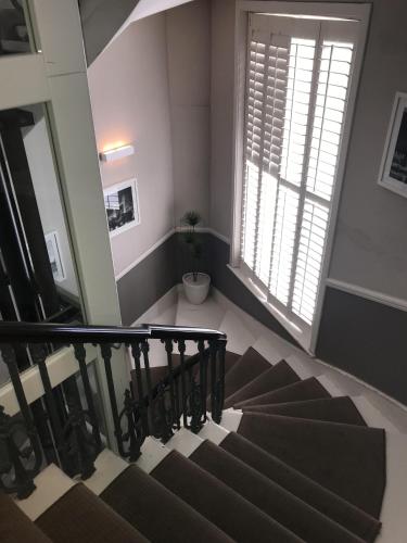 a spiral staircase in a house with a window at Ravna Gora in London