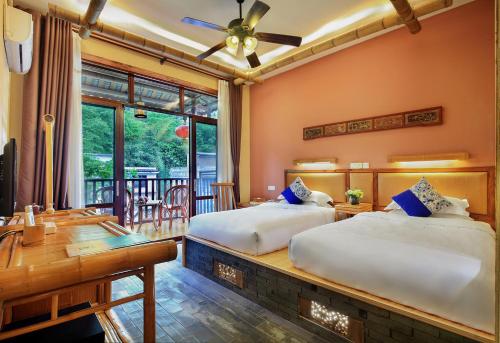 A bed or beds in a room at Yangshuo Mountain Nest Boutique Hotel