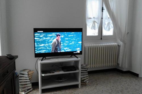 a flat screen tv sitting on a stand in a living room at Appartamento Stefano in Dolcedo