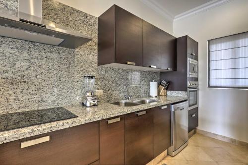 a kitchen with a sink and a counter top at Walk to Beach Modern Cabo Condo with Balcony! in Cabo San Lucas