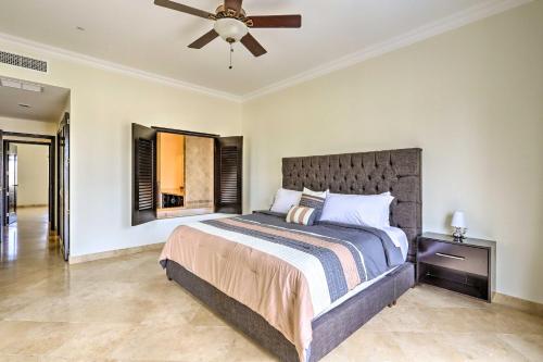 a bedroom with a bed and a ceiling fan at Walk to Beach Modern Cabo Condo with Balcony! in Cabo San Lucas