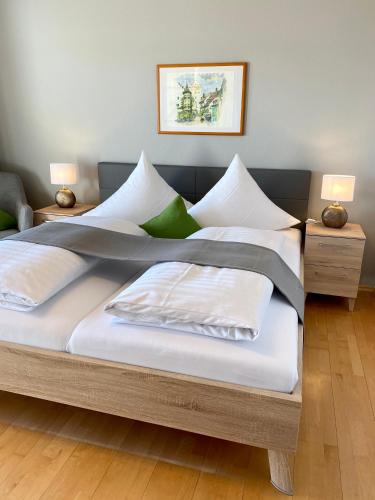 a bedroom with two beds with white pillows at Hotel Landhaus Sternen in Sipplingen