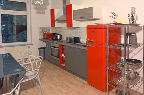 a red refrigerator in a kitchen with a table at stylish city apartment in Zwickau in Zwickau