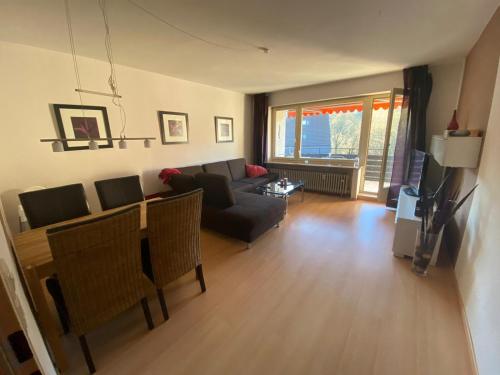 a living room with a couch and a table at Schöne Ferienwohnung in Lautenthal im Harz in Lautenthal
