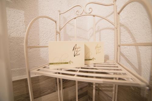 two boxes sitting on top of a white crib at Aria di Vico Aparthotel in Vico del Gargano