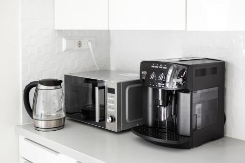 a coffee maker sitting on top of a kitchen counter at 3 Bedroom Apartment 24h self check in, free parking, Ac, fireplace in Vilnius