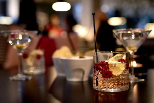 a glass with fruit and ice on a table at IKEA Hotell in Älmhult