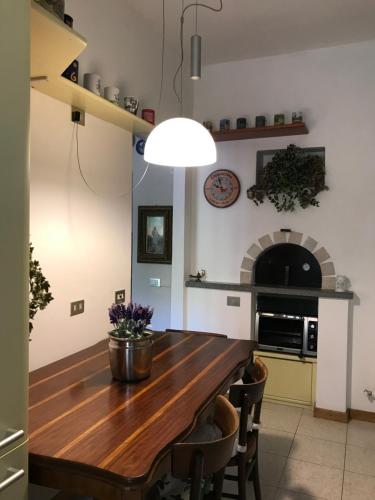 a dining room with a wooden table and a fireplace at Gerry Home in Valmadrera