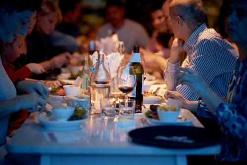 a group of people sitting at a table eating food at IKEA Hotell in Älmhult