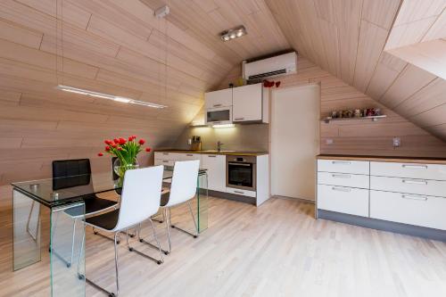 a kitchen with a glass table and white cabinets at Villa Bach in Valgeranna