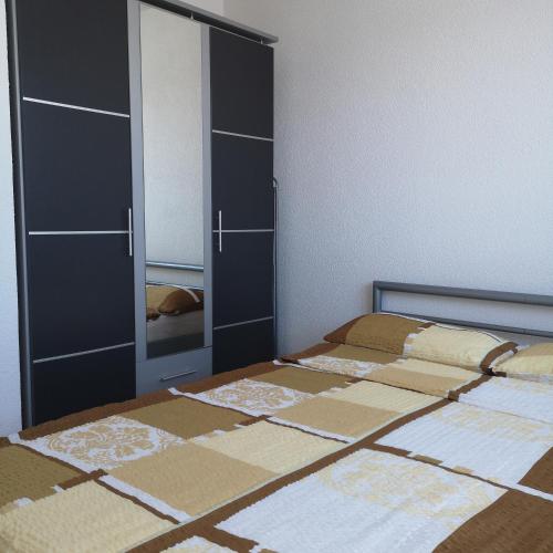 a bedroom with two beds and a large cabinet at Ferienwohnung Noll in Friedrichshafen