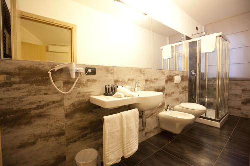 a bathroom with a sink and a toilet at Hotel La Meridiana in Settimo Torinese