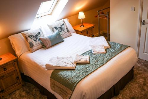 a bedroom with a bed with towels on it at The Shoulder Of Mutton Inn in Hamstall Ridware