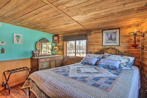 A bed or beds in a room at Cabin on Private Island Less Than 6 Mi to Sand Valley Golf