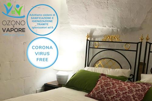 a bedroom with a bed and a sign that says corona virus free at Ponticelli B&B Boutique in Gravina in Puglia