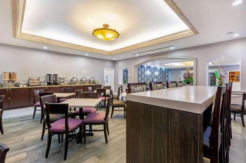 a restaurant with a bar and tables and chairs at La Quinta by Wyndham Cd Juarez Near US Consulate in Ciudad Juárez
