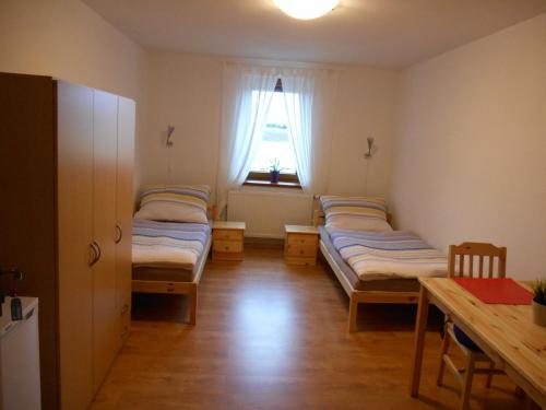 A bed or beds in a room at Penzion Pohůrka