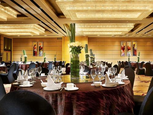 a conference room with a long table with wine glasses at Enlux Hotel in Jinan