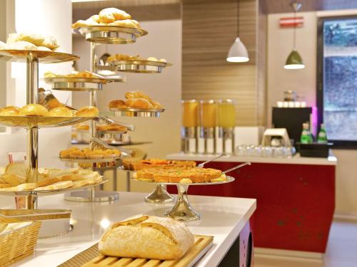 a table topped with lots of different types of food at Mercure Roma Centro Colosseo in Rome