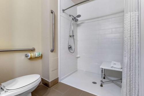 a bathroom with a toilet and a shower at Comfort Inn University Wilmington in Wilmington
