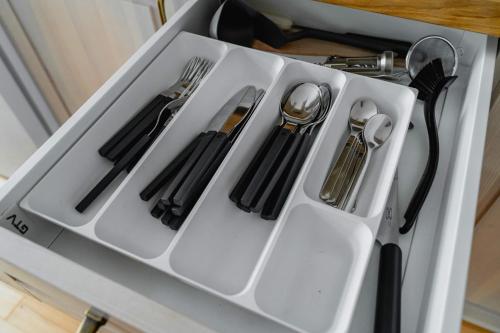 a white tray with utensils in a drawer at Stará Škola Hedeč in Králíky