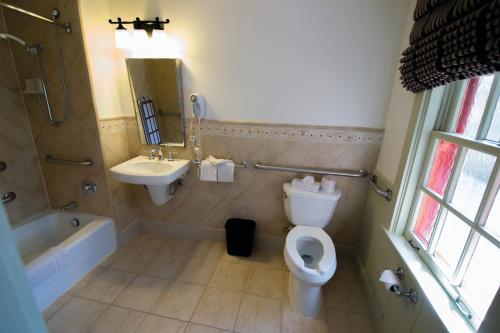 a bathroom with a toilet and a sink and a tub at Bright Angel Lodge - Inside the Park in Grand Canyon Village