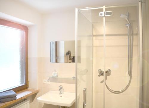 a bathroom with a shower and a sink at Pension Almhof Baumgarten in Bad Reichenhall