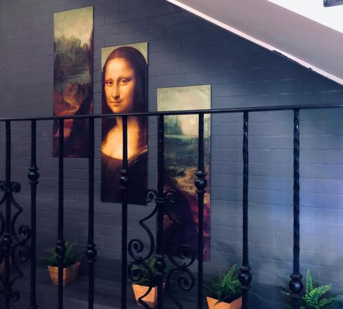 a painting of a woman on the side of a house at Villa Mona Lisa in Hévíz