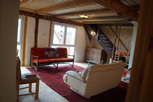 a living room with a couch and a chair at CASA-Li old Farmhouse in Tengen