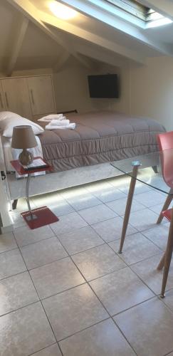 a bedroom with a bed and a tv in a room at Alexia's Apartments in Rio