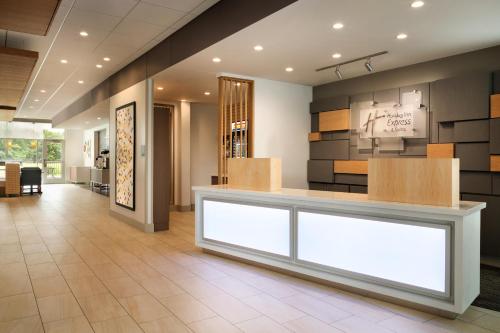 a lobby with a reception desk in a building at Holiday Inn Express & Suites - Grand Rapids South - Wyoming, an IHG Hotel in Wyoming