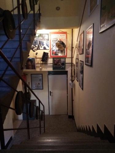 a hallway with a staircase with a door and pictures at Apartmány Rossa in Louny