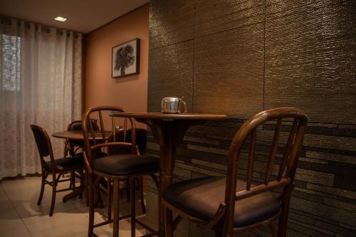 a row of tables and chairs in a restaurant at Regente Hotel in Pato Branco