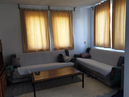 a living room with two couches and a coffee table at Lake House in Novi Pazar