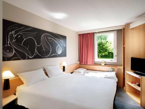 Кровать или кровати в номере ibis Thionville Porte du Luxembourg