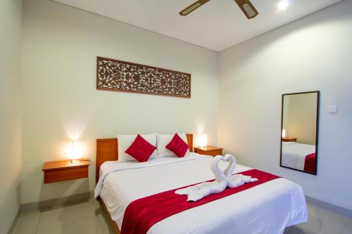 a hotel room with a bed with a swan on it at Asoka Hotel & Suite in Sanur