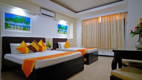 A bed or beds in a room at Boracay Holiday Resort