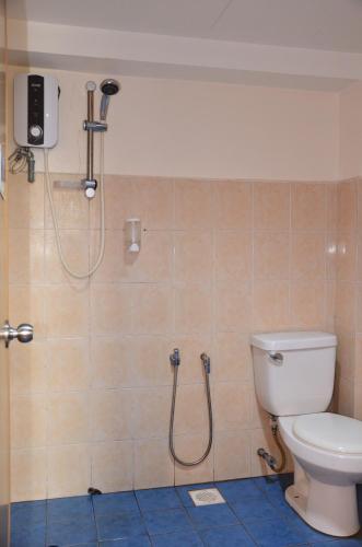 a bathroom with a toilet and a shower in it at Uptown Hotel Kajang in Kajang