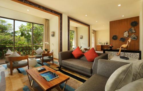 a living room with a couch and a table at The Seminyak Beach Resort & Spa in Seminyak